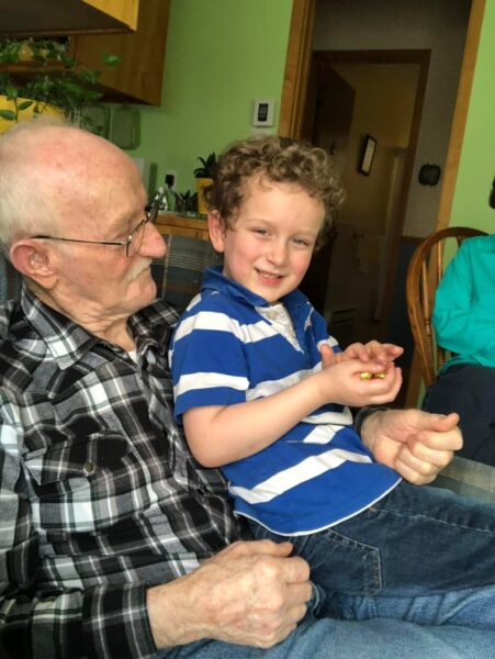 Young boy on lap of older man