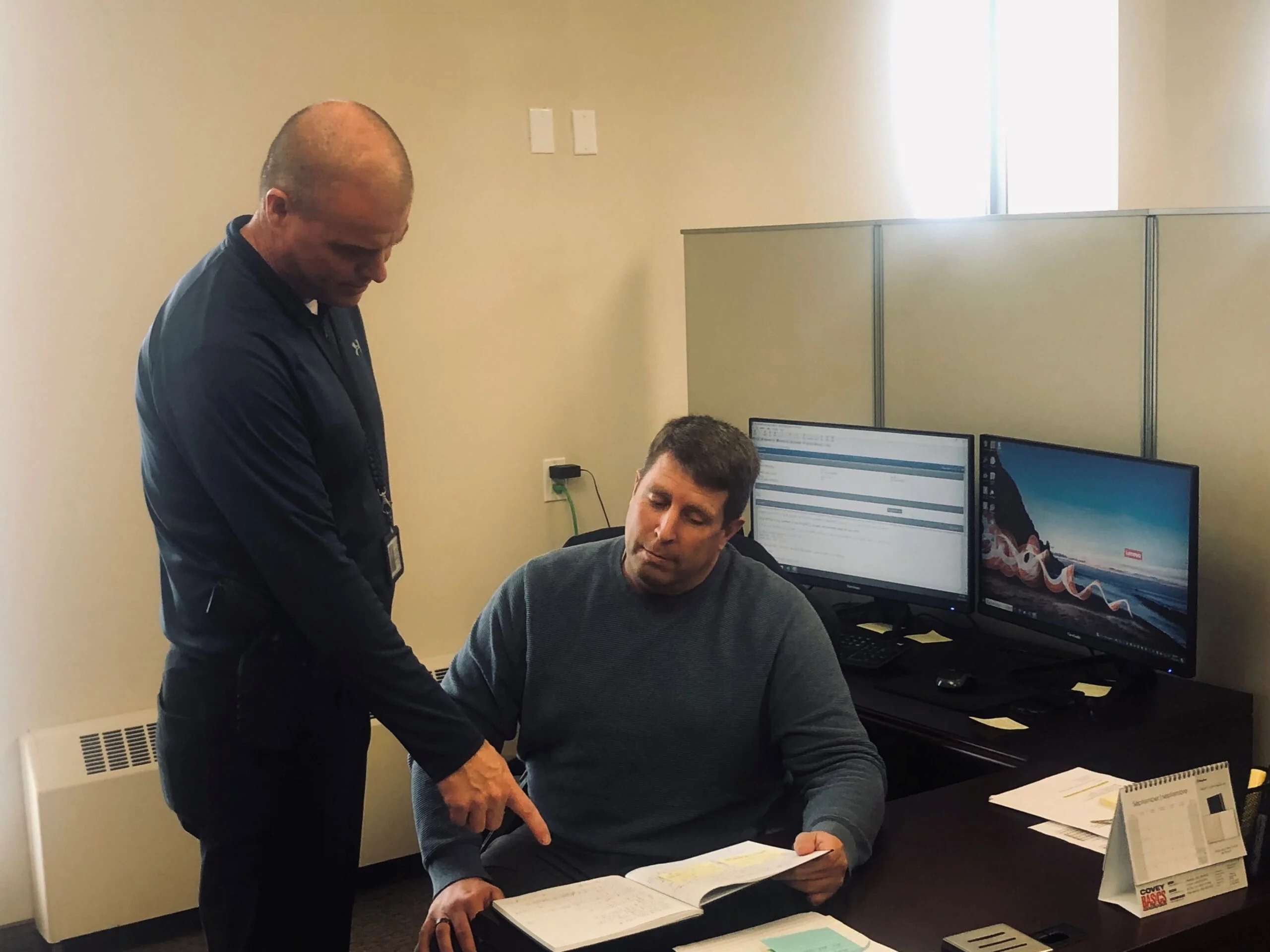 Staff Sgt. Jeff Matthews, standing, and Cst. John Morrison of WPF’s Street Crime Unit are at work in their office in the former council chambers. (Jim Dumville photo)