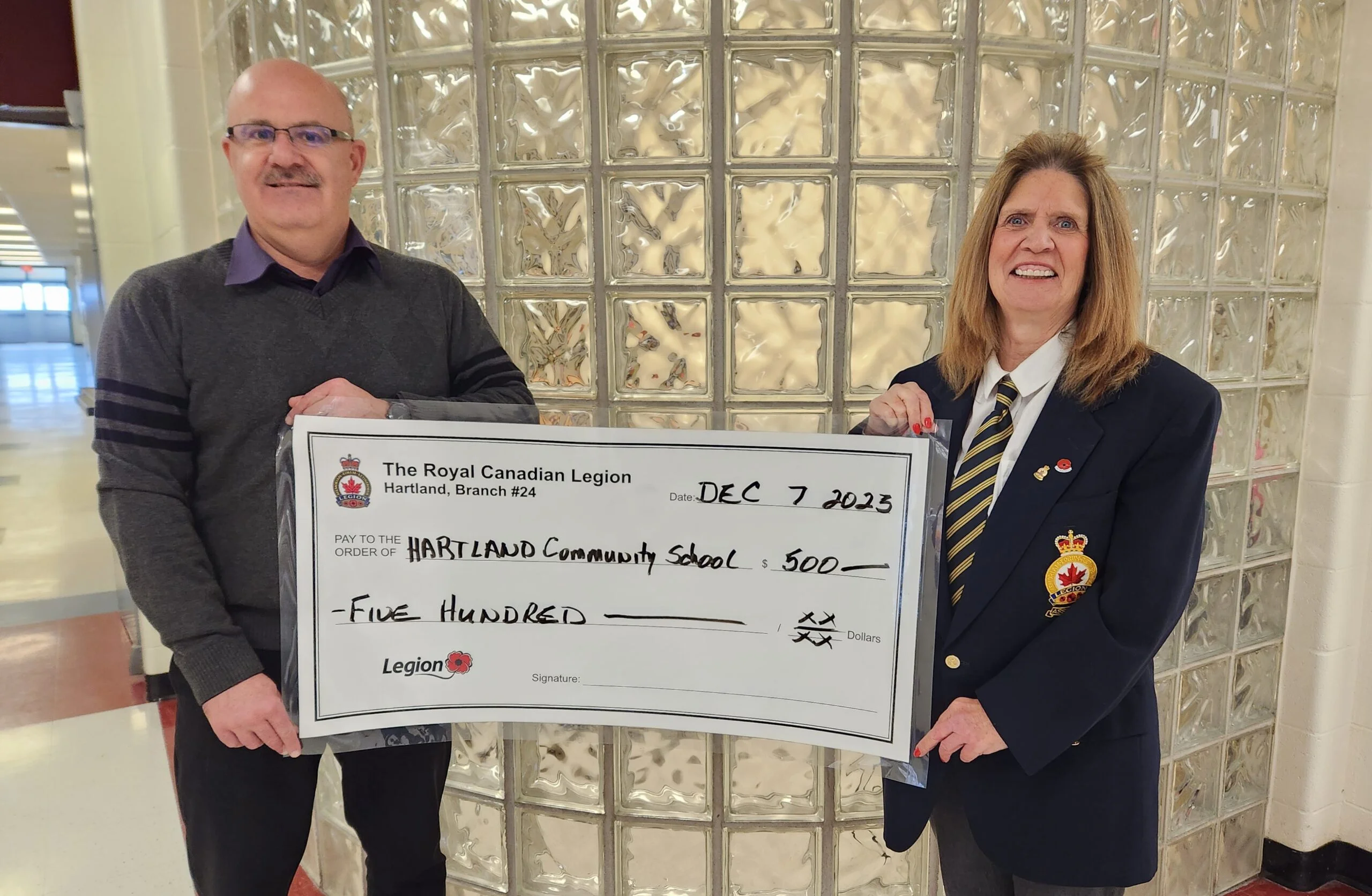 Cheryl Broad, treasurer of Hartland Branch 24 of the Royal Canadian Legion, presents a $500 cheque to Hartland Community School Principal Andy Clark from its “Chase the Ace” proceeds. (Submitted photo)
