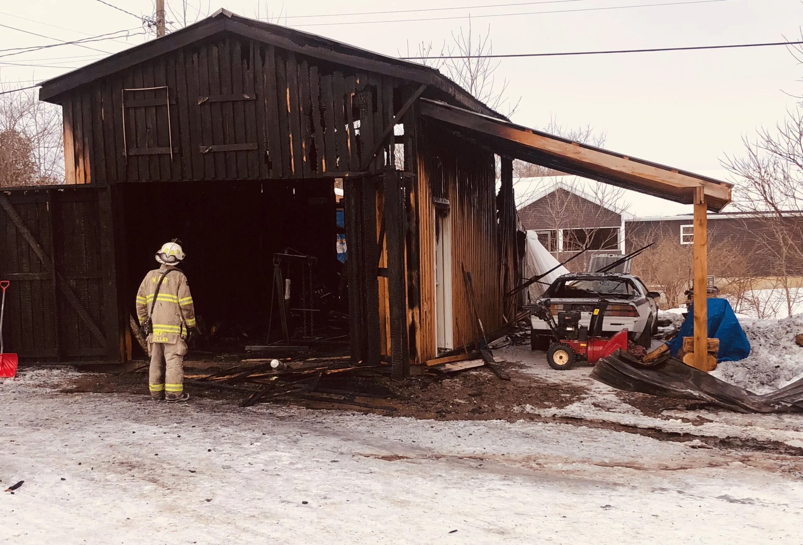 Woodstock Fire Chief Harold McLellan checks out the remains of a garage destroyed by fire Tuesday morning, Feb. 6. (Jim Dumville photo)
