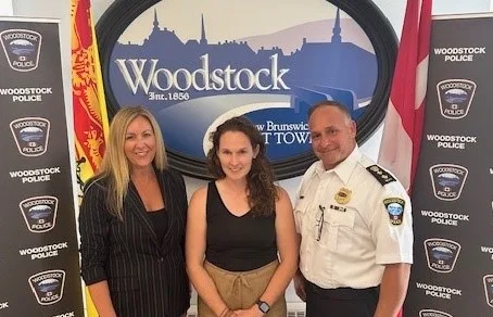 Woodstock Mayor Trina Jones, left, and interim Woodstock Police Chief Mark Bennett, right, welcome Cst. Abby Derrah as the forces ntimate Partner Violence (IPV) Investigator and Coordinator. (Submitted photo)