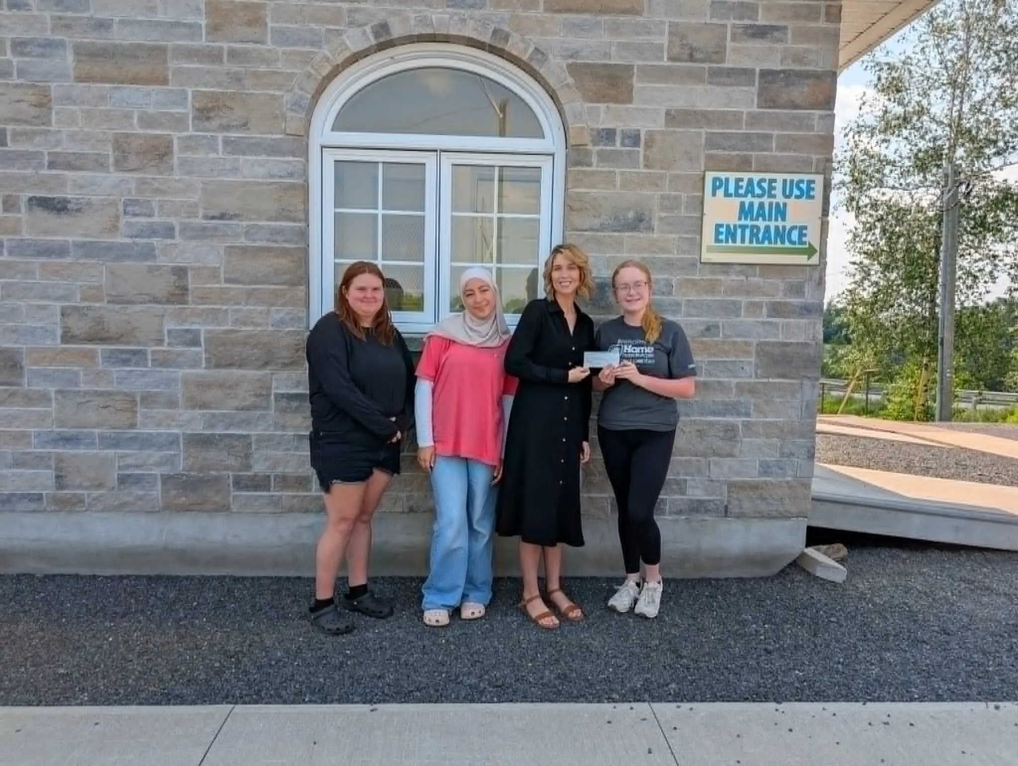 Woodstock High School students present Sanctuary House with a cheque after fundraising this spring.From left, Maxx Robillard, Malak Ahmed, Sloane Rees, and Hope Foster. (Dawn Koeber photo)