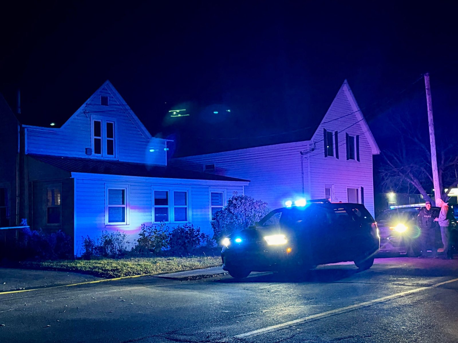 Police tape drapes across the driveway of a home on Houlton Street in Woodstock after a woman was stabbed on Monday night, Oct. 20. (Theresa Blackburn photo)