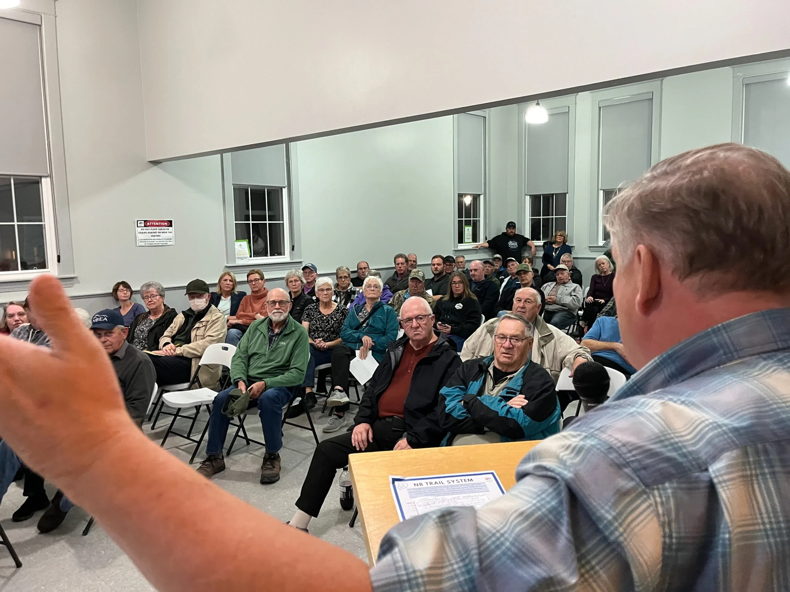 District of Carleton North Mayor Andrew Harvey addresses the public at the Oct. 23 meeting concerning ATV access on the Wolastoq Valley Trail. (Remko van Rhijin photo)