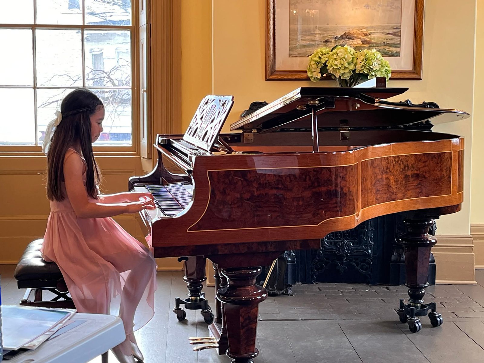 Lois Villasaya (age eight) playing “Mamma Mia” and “God is Watching Over Us” at the Historic Connell House. (Erin Seifarth photo)