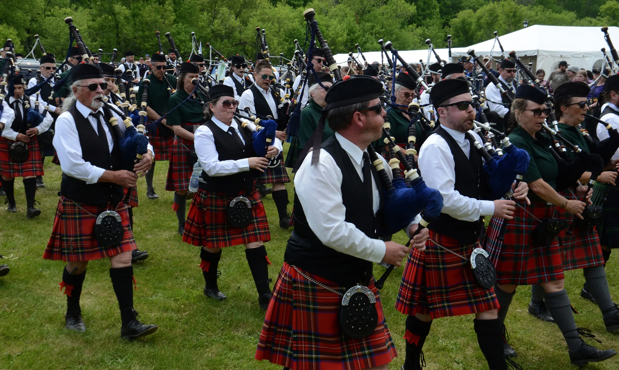 Members of the Southern Victoria Pipe Band, the Saint John Caledonia Pipe Band and the Fredericton Society of Saint Andrew Pipe Band march into the Gathering of the Scots for the opening ceremonies Saturday, June 6. (Submitted photo)