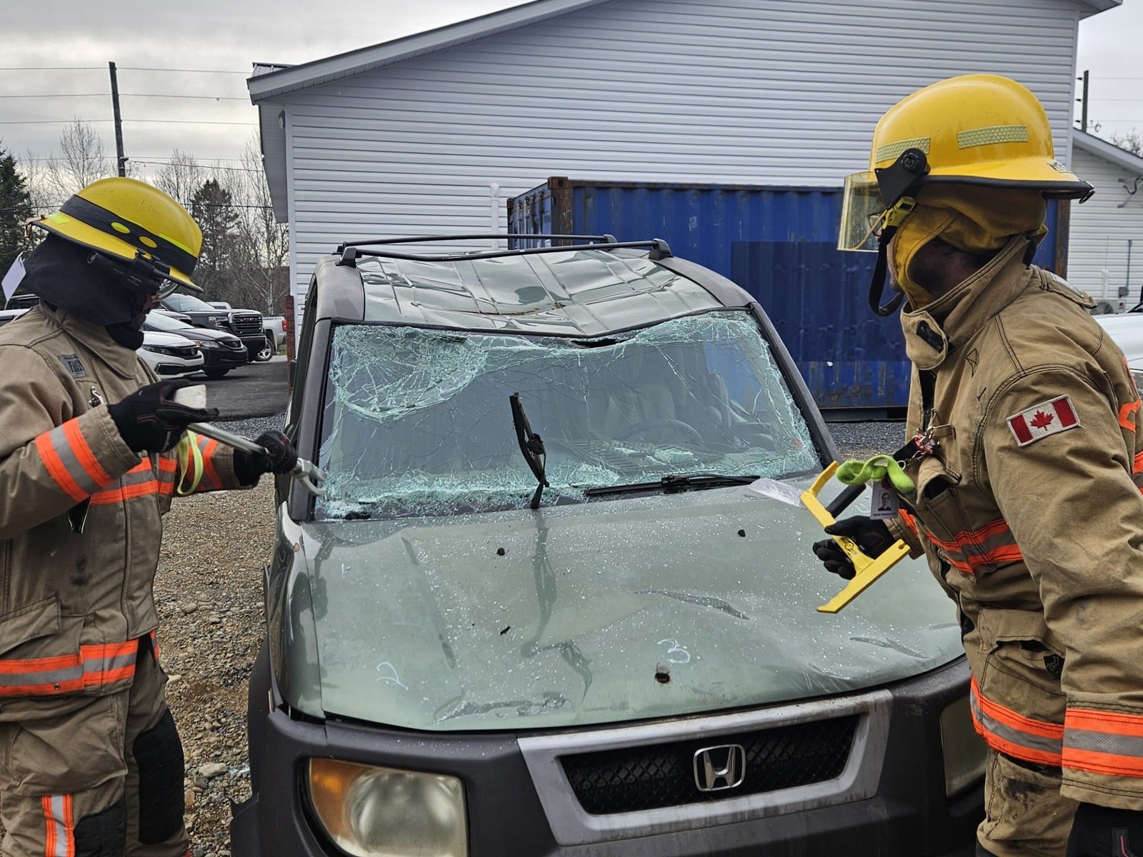 (From left) Carson McIntosh and Dallas Pearson practicing car rescue procedures for the Glassville Fire Department. (Connor Barry photo)