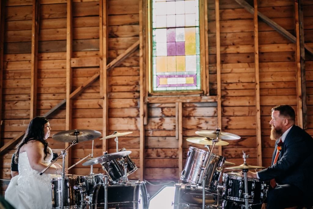 Melody and Matthew playing their drum sets at their wedding reception at the Tabernacle in Somerville. (Katie Hawkins photo))