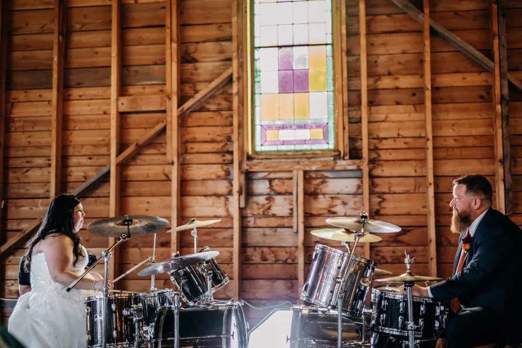 Melody and Matthew playing their drum sets at their wedding reception at the Tabernacle in Somerville. (Katie Hawkins photo))